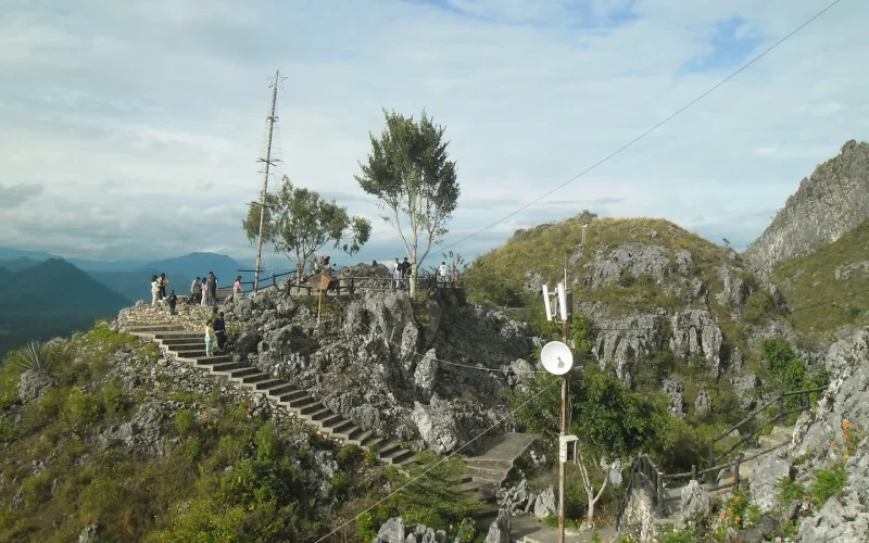 Stone stairway climbing the cliff at Buntu Burake with highland ranges beyond, Tana Toraja