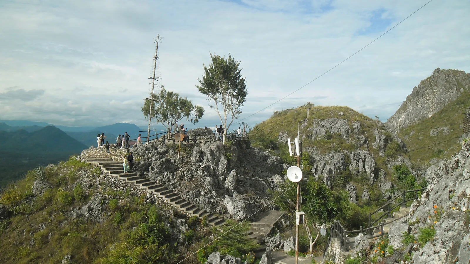 Stone stairway climbing the cliff at Buntu Burake with highland ranges beyond, Tana Toraja