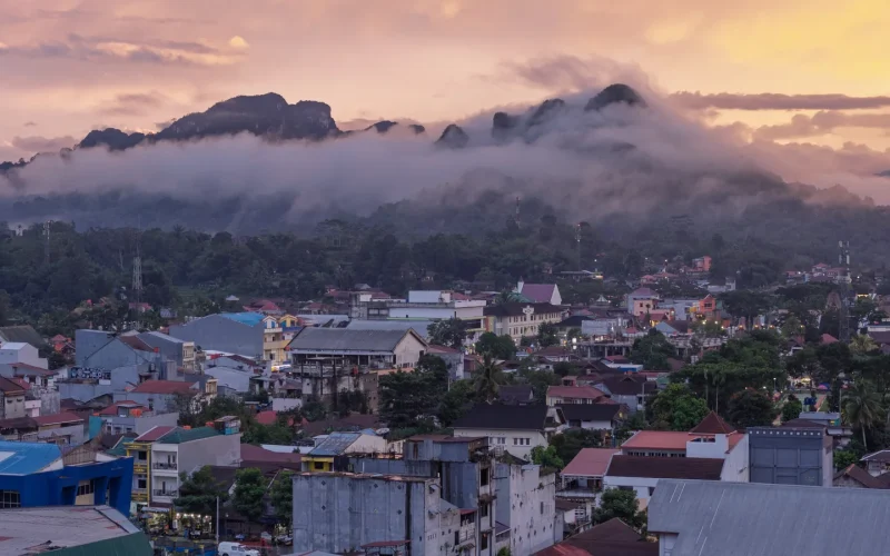 Rantepao town spread across the valley floor beneath cloud-wrapped mountains, Tana Toraja