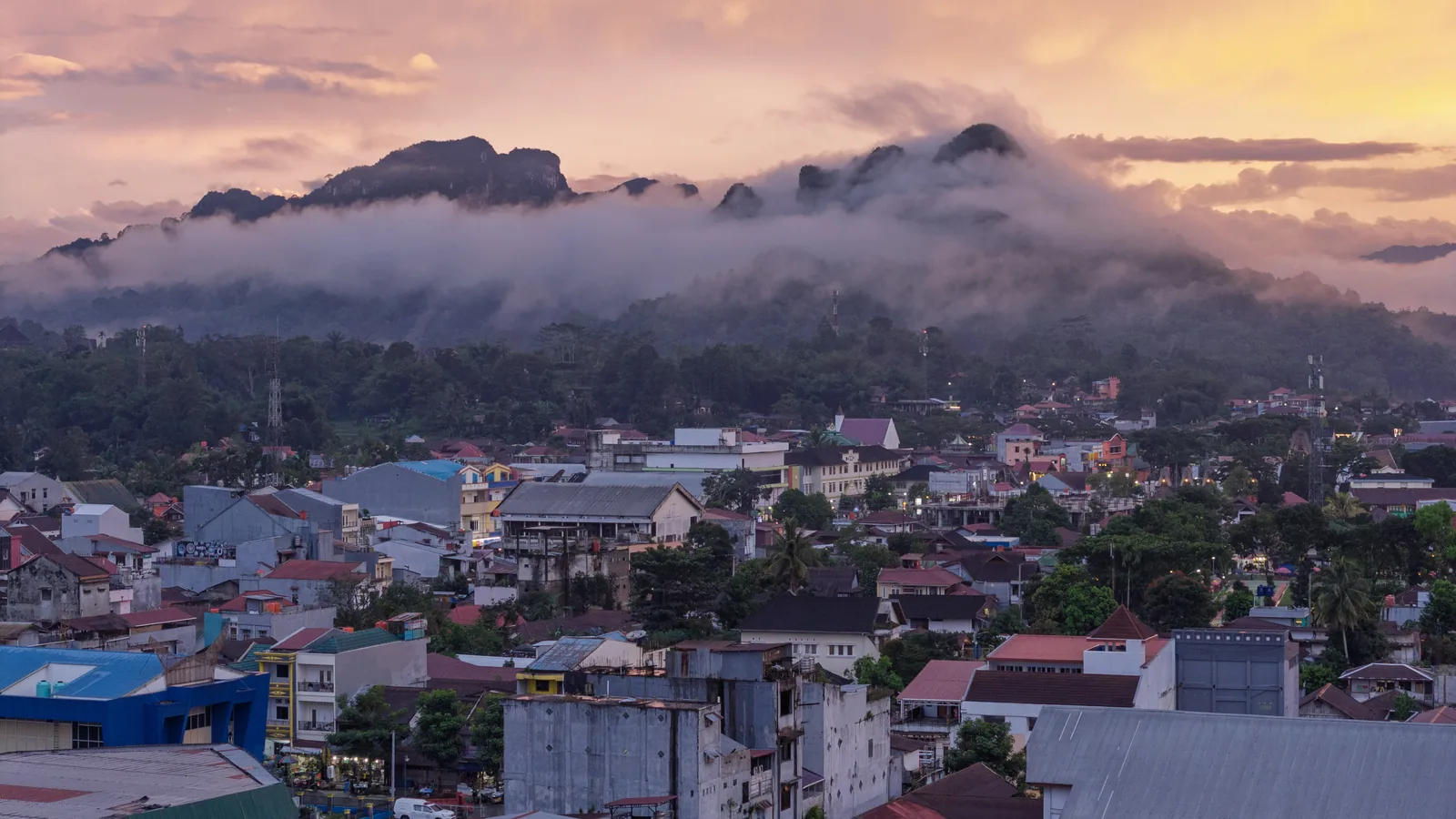 Rantepao town spread across the valley floor beneath cloud-wrapped mountains, Tana Toraja