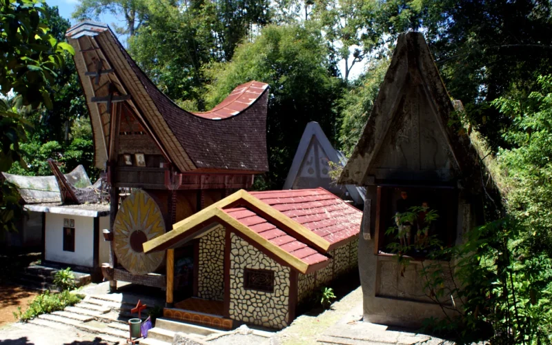 Tongkonan houses with decorated gables among greenery at Kete Kesu, Tana Toraja