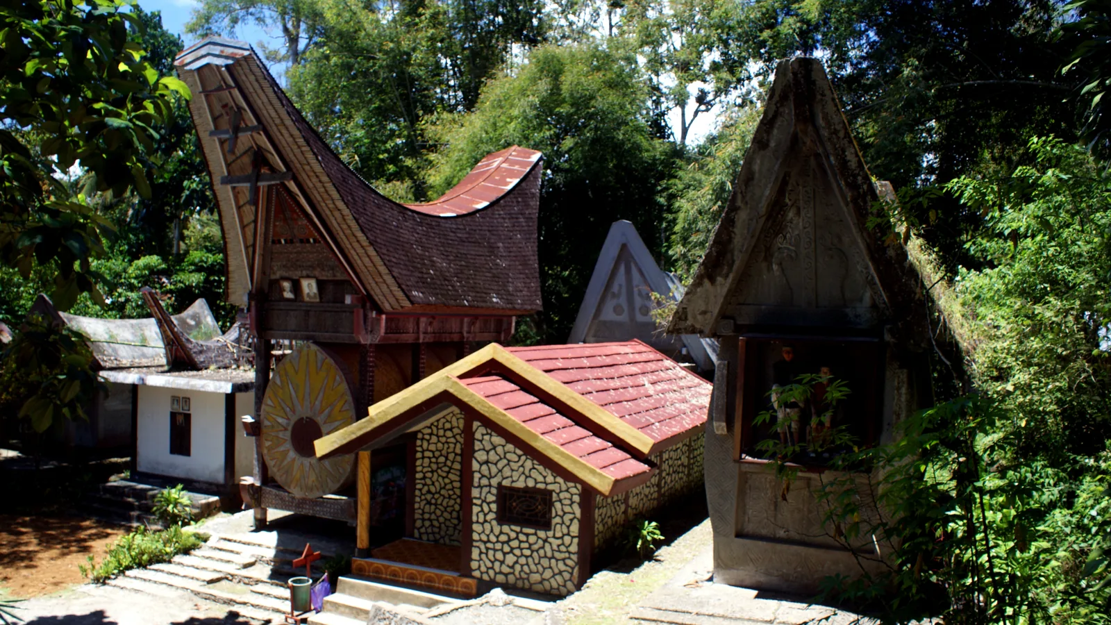 Tongkonan houses with decorated gables among greenery at Kete Kesu, Tana Toraja
